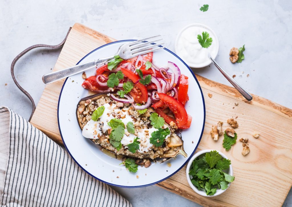 Couscous stuffed aubergine recipe with a tomato and onion salad